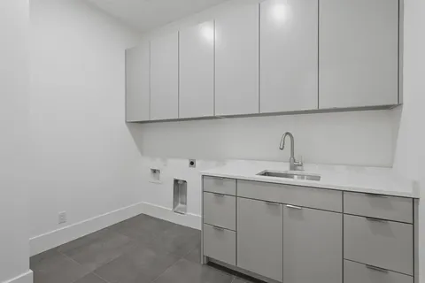 a kitchen with white cabinets and a sink