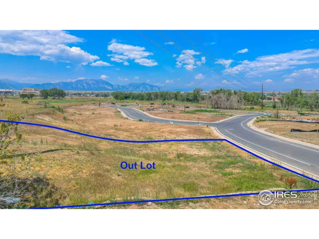 a view of a field with an ocean