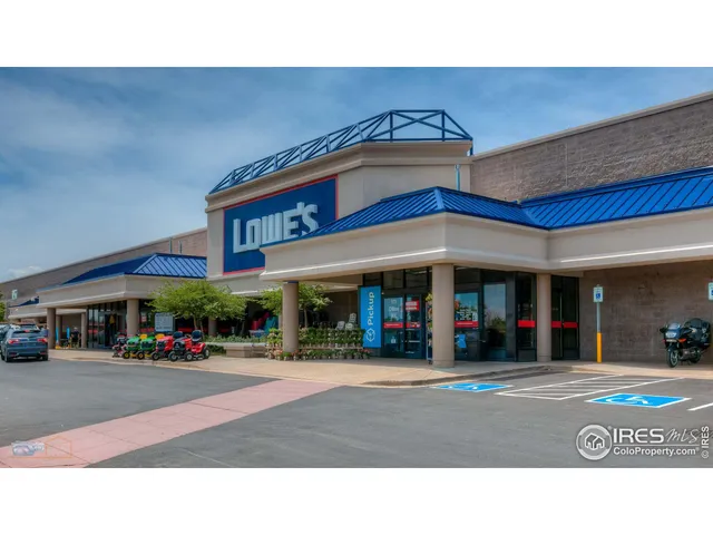 a black and white house with a yard in front