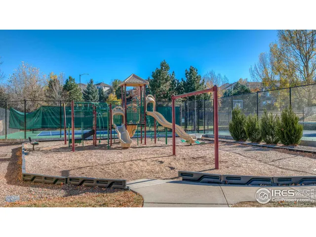 a open area with tall buildings in the background