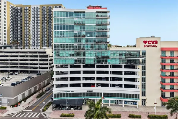 a living room with furniture flower pot and a flat screen tv