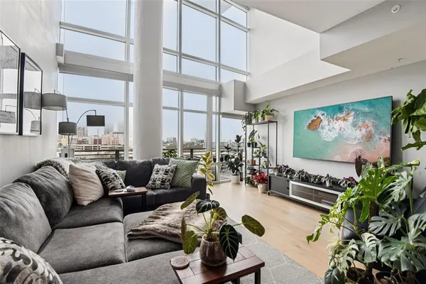 a kitchen with granite countertop a table chairs stove and refrigerator