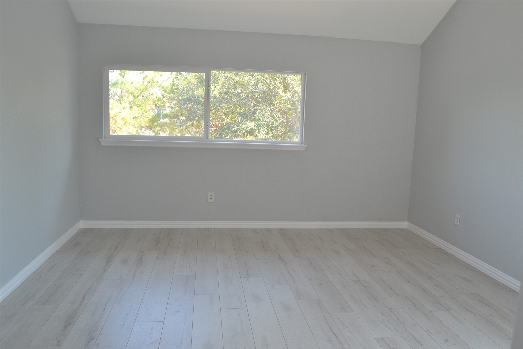 2242 Gray Hawk Lane Katy, TX 77449 - Photo 27 of 32 an empty room with wooden floor and windows