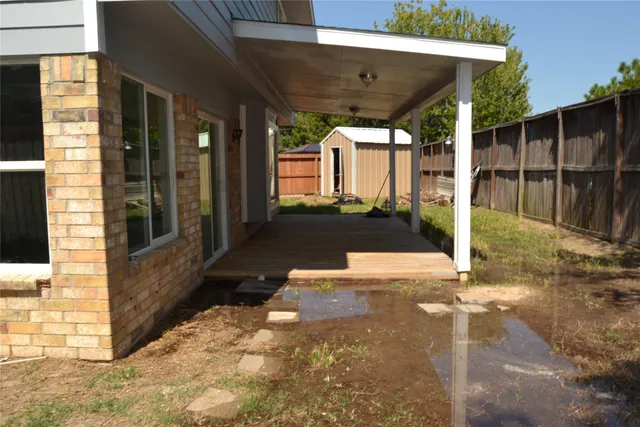 a view of a porch with a table and chairs
