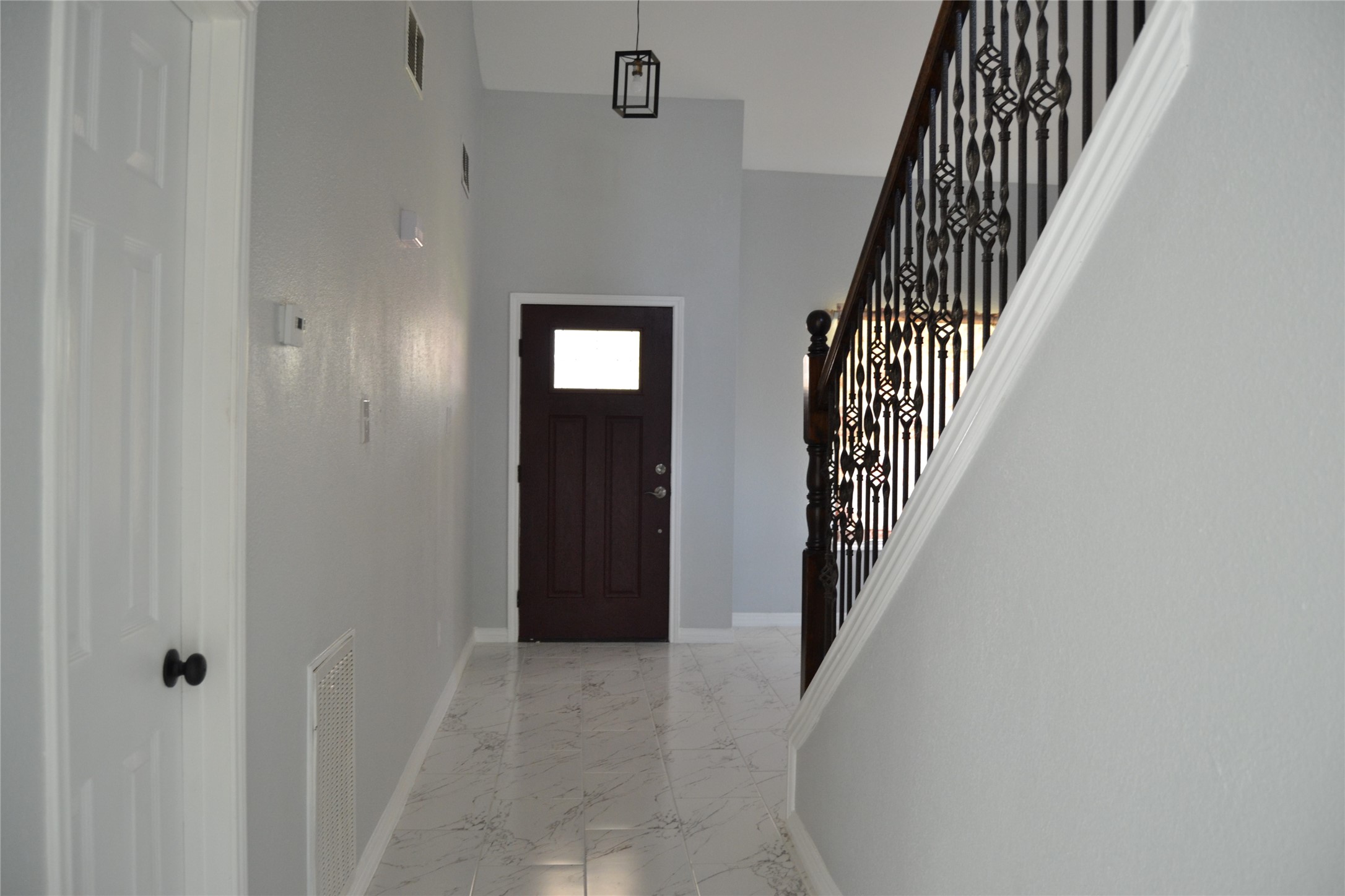2242 Gray Hawk Lane Katy, TX 77449 - Photo 4 of 32 a view of a hallway with wooden floor and entryway