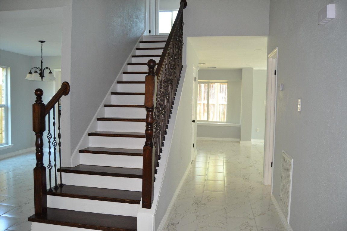 2242 Gray Hawk Lane Katy, TX 77449 - Photo 6 of 32 Remodeled stairway with iron balusters