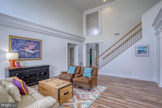 a living room with furniture and stairs