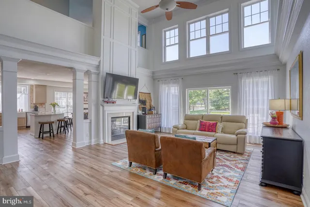 a living room with fireplace furniture and a wooden floor