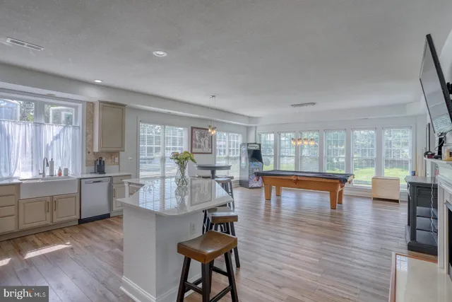 a living room with fireplace furniture and a wooden floor