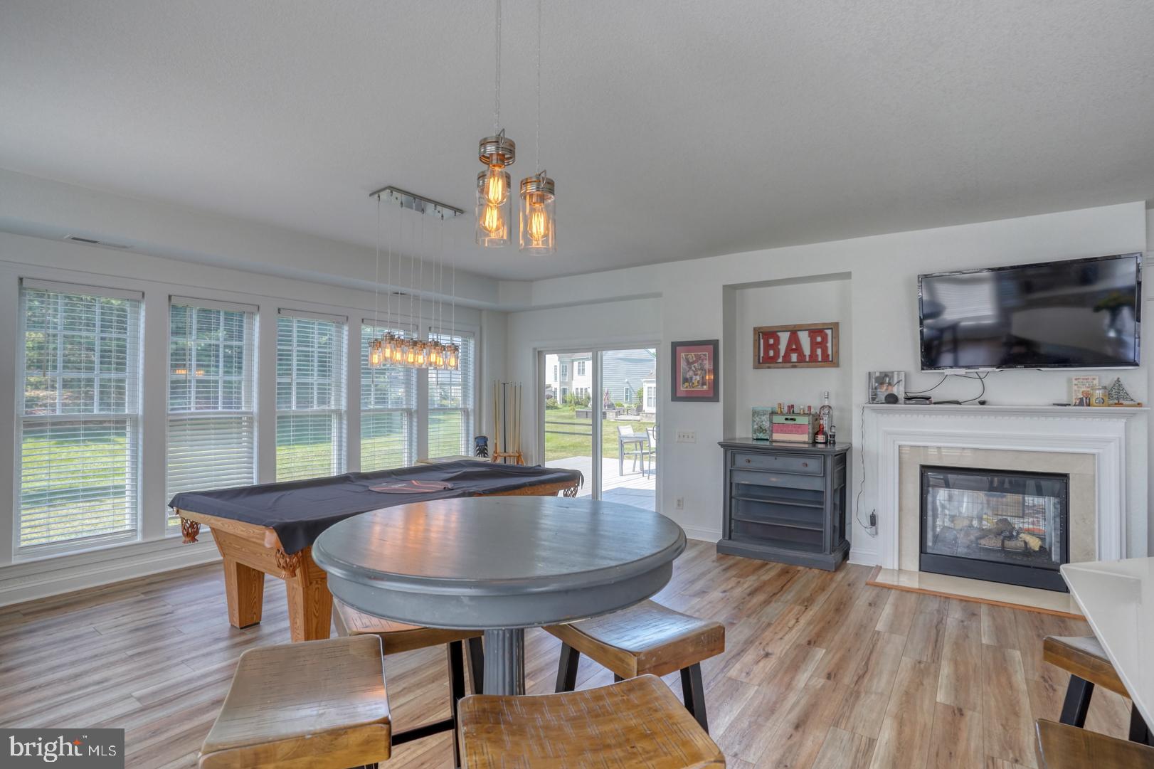34026 Joyce Court Lewes, DE 19958 - Photo 20 of 48 a dining room with furniture a chandelier and wooden floor