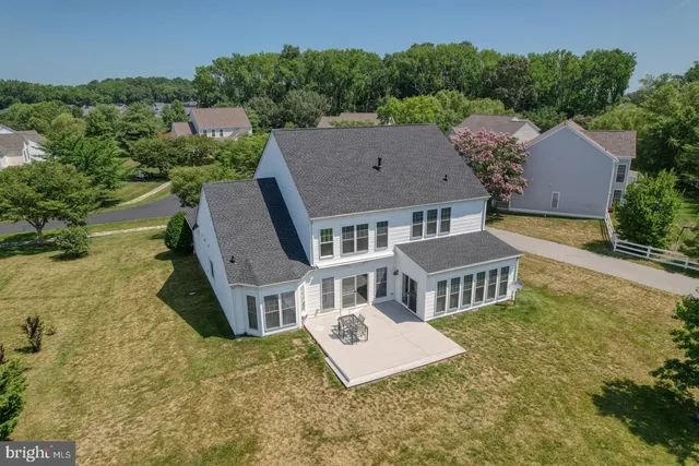 an aerial view of a house with swimming pool and garden