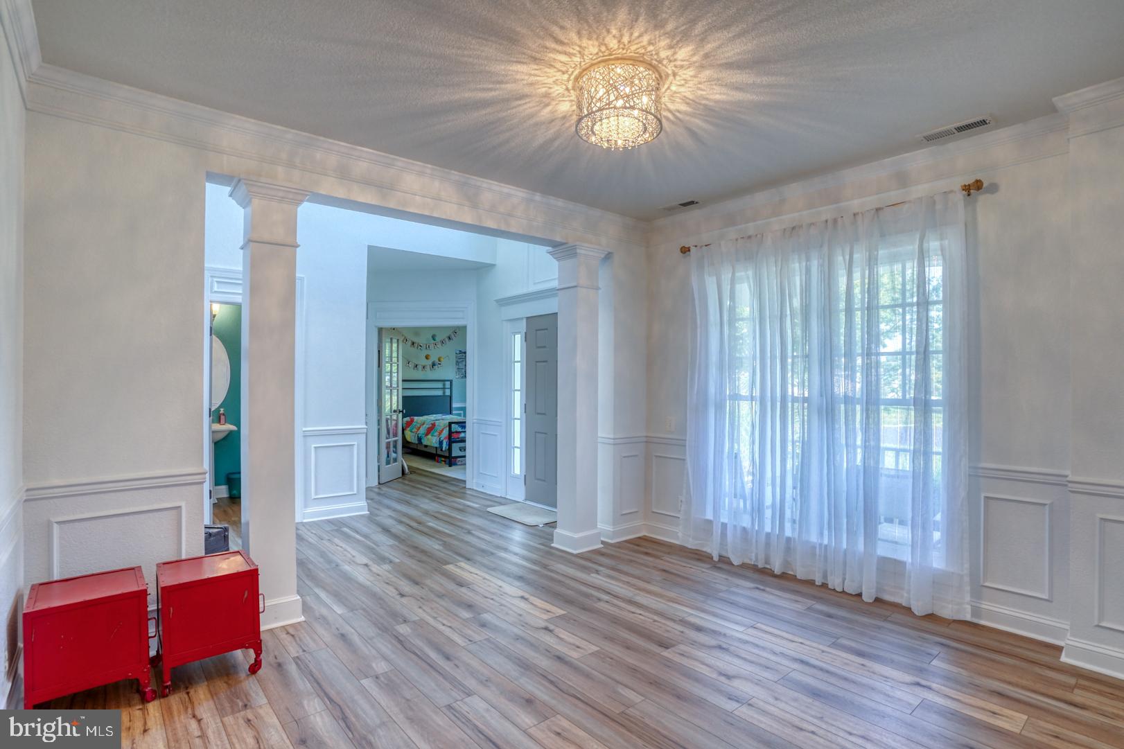 34026 Joyce Court Lewes, DE 19958 - Photo 22 of 48 wooden floor in an empty room with a window