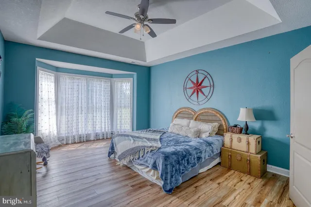 a bedroom with a bed and a potted plant