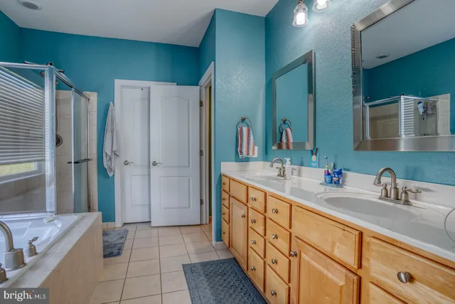 a bathroom with a double vanity sink and a mirror