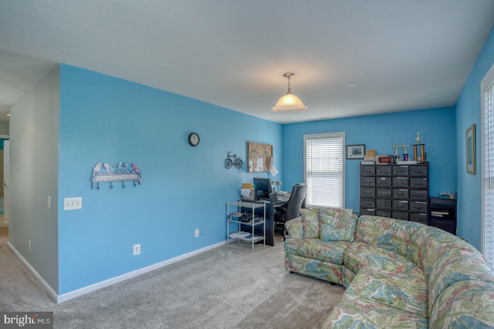 34026 Joyce Court Lewes, DE 19958 - Photo 30 of 48 a living room with furniture and a lamp