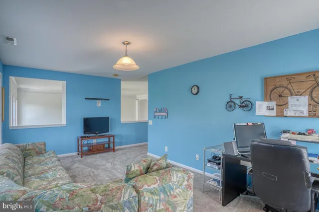 a bedroom with furniture and a flat screen tv