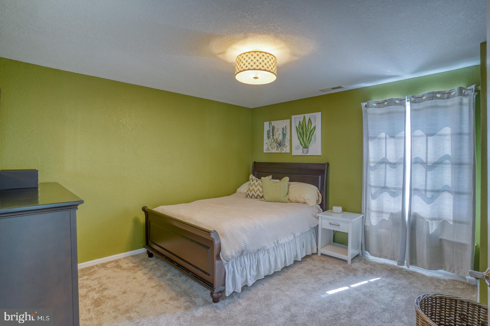 34026 Joyce Court Lewes, DE 19958 - Photo 37 of 48 a bedroom with a bed and a chandelier