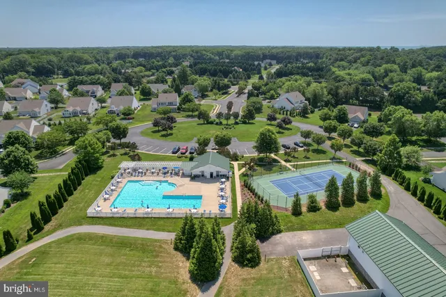 an aerial view of a house with a garden and lake view