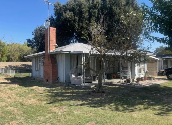 a view of a house with backyard porch and sitting area