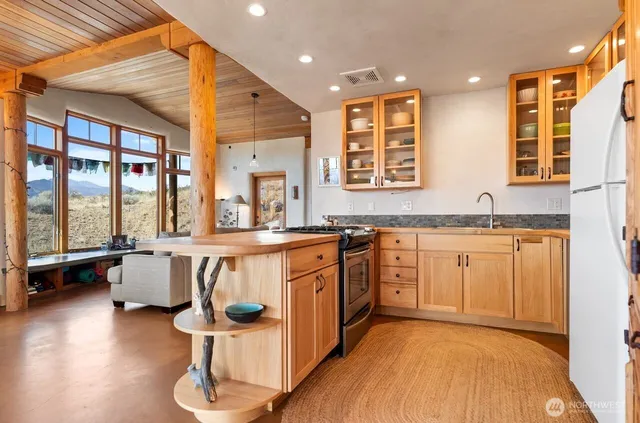 a large kitchen with stainless steel appliances granite countertop a sink and cabinets
