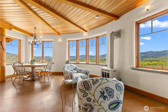 a living room with furniture and floor to ceiling windows