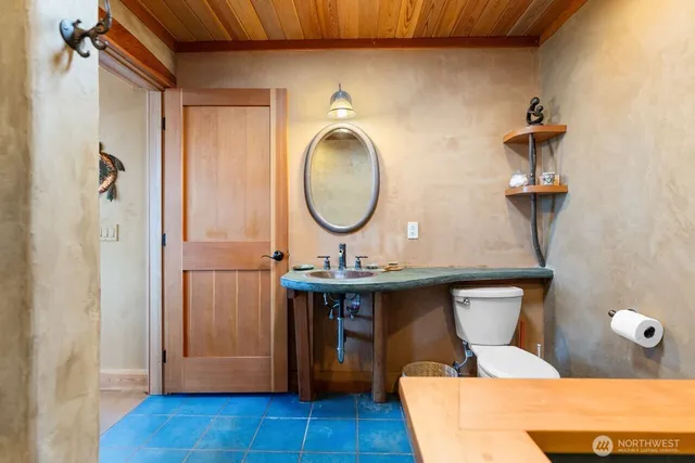 a view of a bathroom with a sink and mirror
