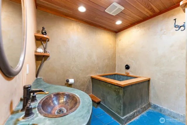 a bathroom with a sink a toilet and a mirror