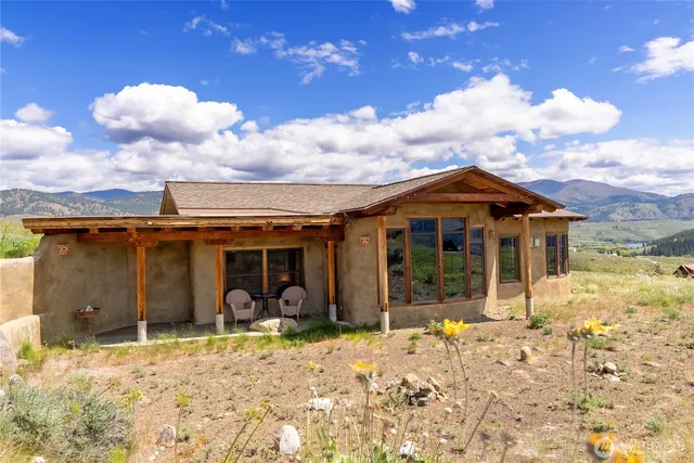a view of a house with yard and wooden fence