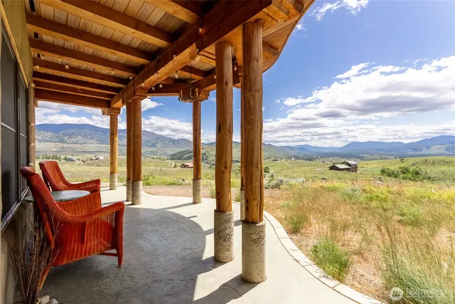 a view of a room with furniture and a mountain view