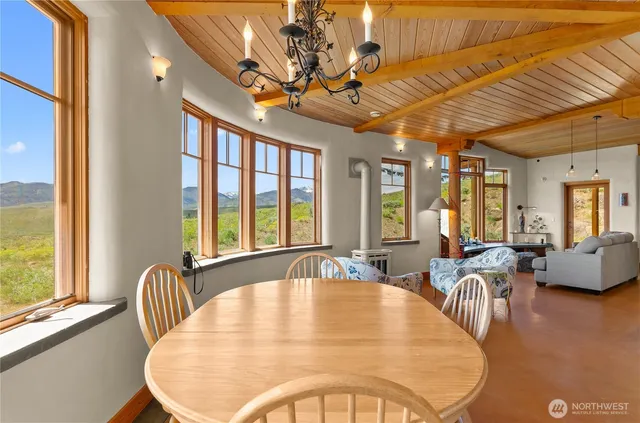 a dining room with furniture a chandelier and wooden floor