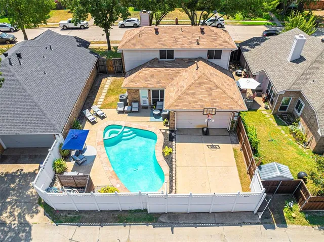 a view of a house with swimming pool and porch with furniture