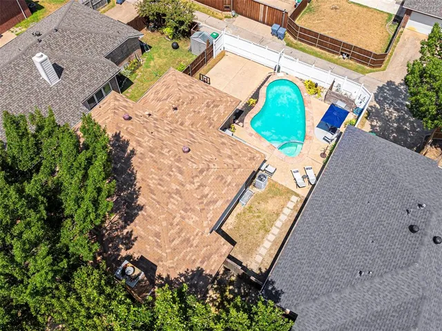 an aerial view of a house with a swimming pool