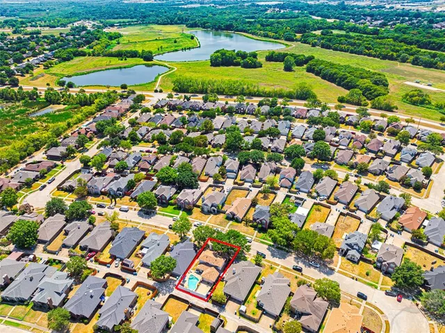 an aerial view of a house with a yard and swimming pool