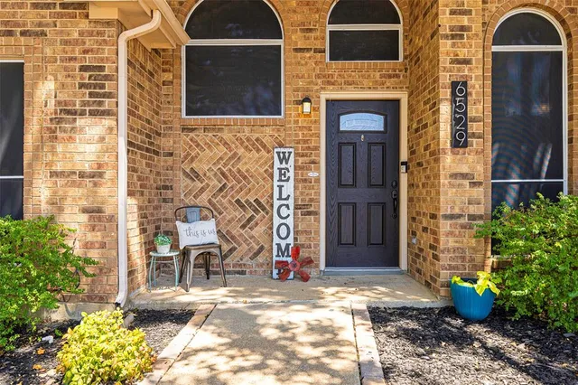 a view of entrance of the house and potted plants