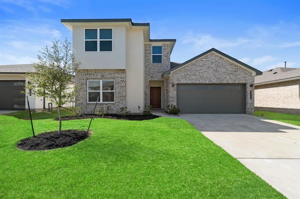 31 Desert Spring Lane Manvel, TX 77578 - Photo 1 of 17 a view of a house with a yard and potted plants