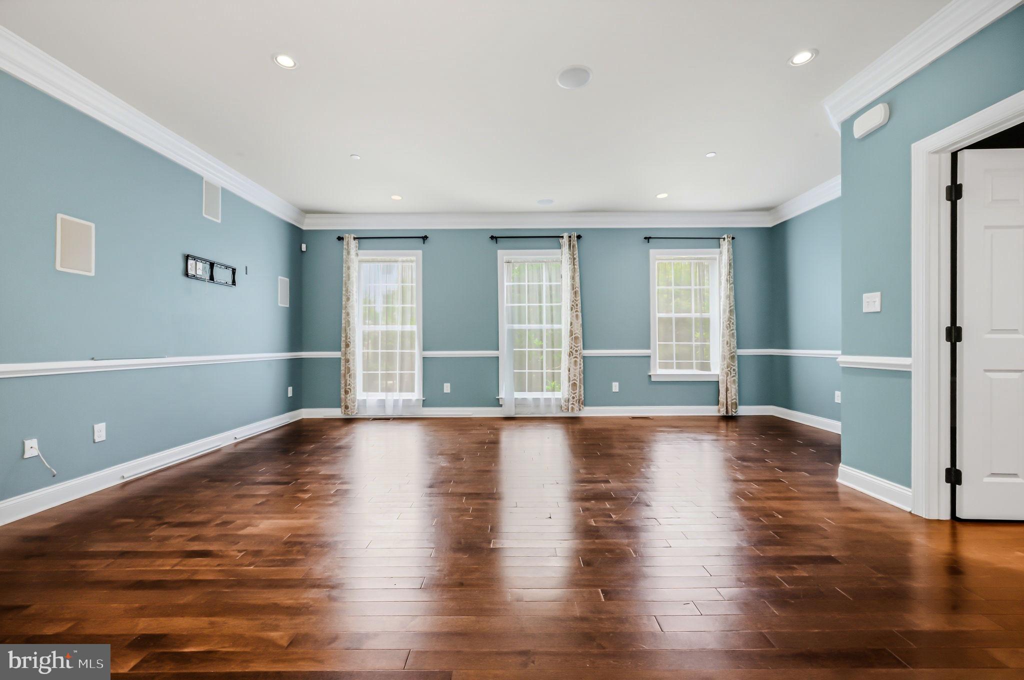 208 Jackdaw Alley, Unit 208 Springfield, PA 19064 - Photo 23 of 49 a view of an empty room with wooden floor and a window