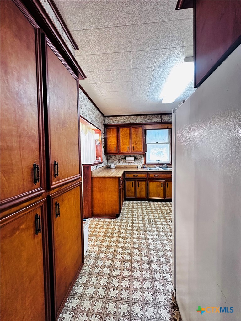 608 Coke Street Yoakum, TX 77995 - Photo 12 of 22 a kitchen with stainless steel appliances granite countertop a refrigerator a stove and a sink