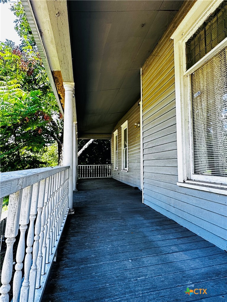 608 Coke Street Yoakum, TX 77995 - Photo 3 of 22 a view of a balcony with wooden floor and fence