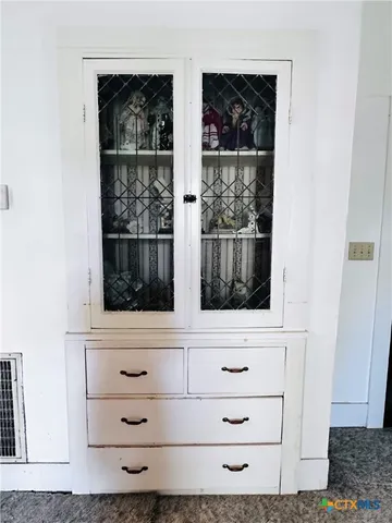a view of an empty room with a fireplace and a window