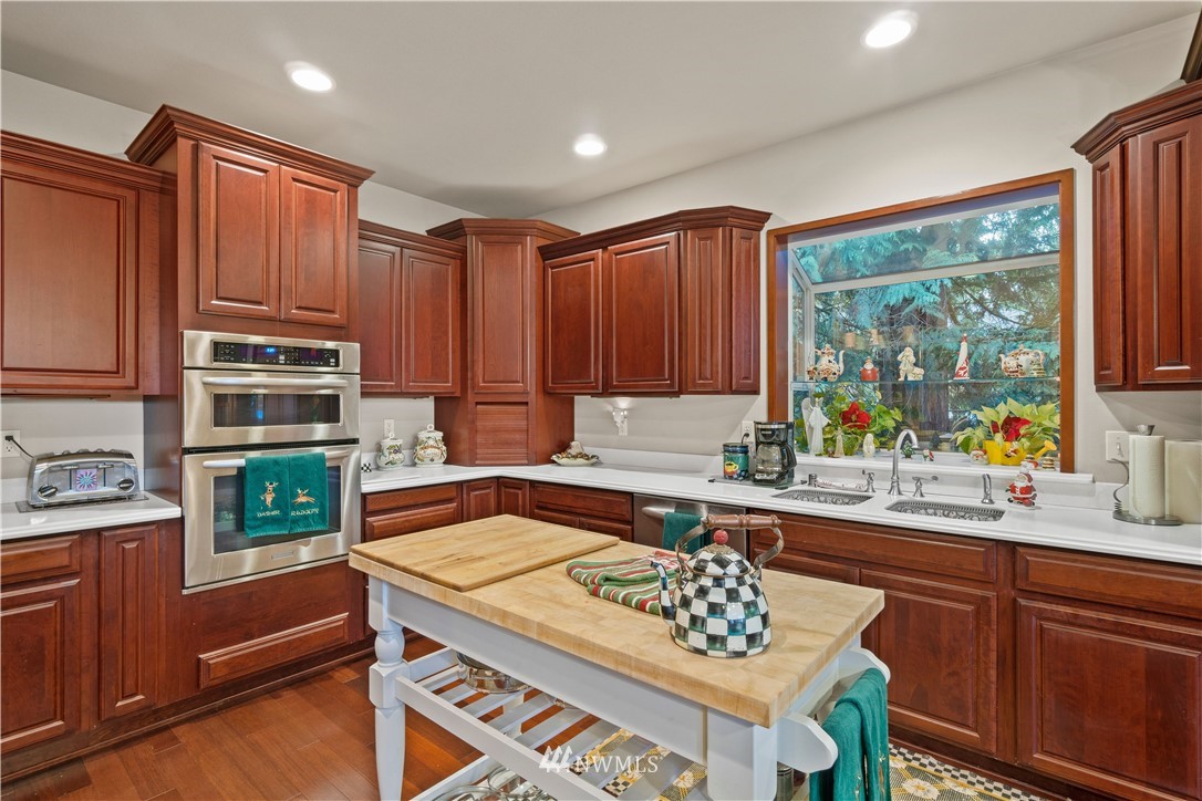 18100 Southeast 132nd Street Renton, WA 98059 - Photo 12 of 33 a kitchen with a stove a sink and a refrigerator