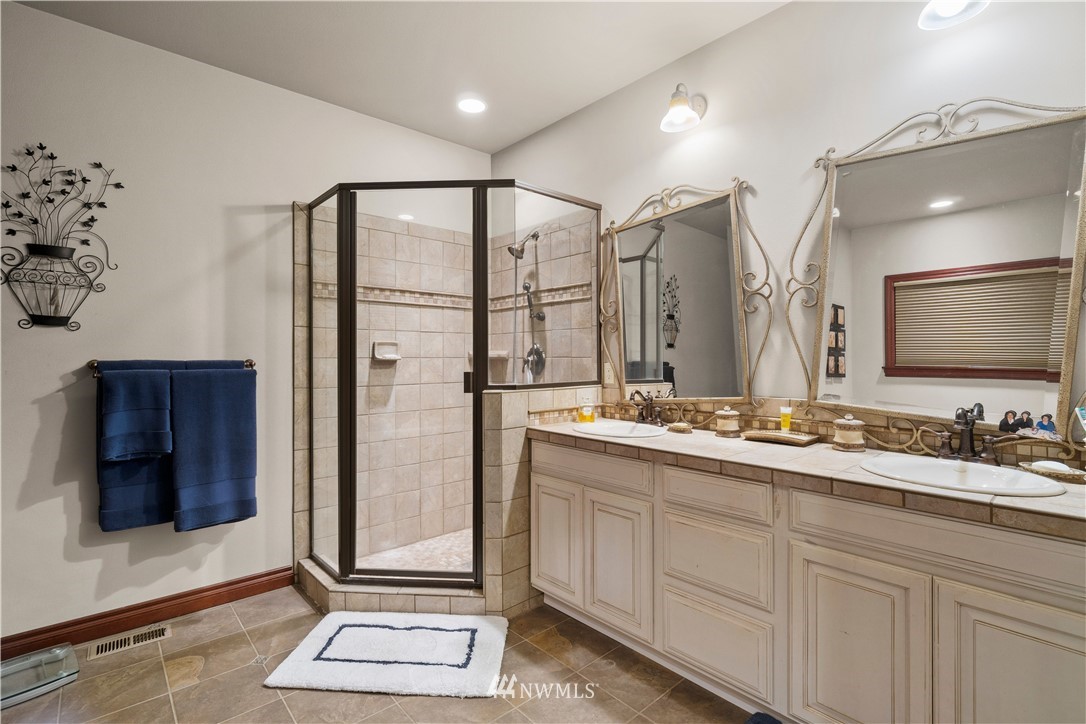 18100 Southeast 132nd Street Renton, WA 98059 - Photo 21 of 33 a bathroom with a double vanity sink and a mirror