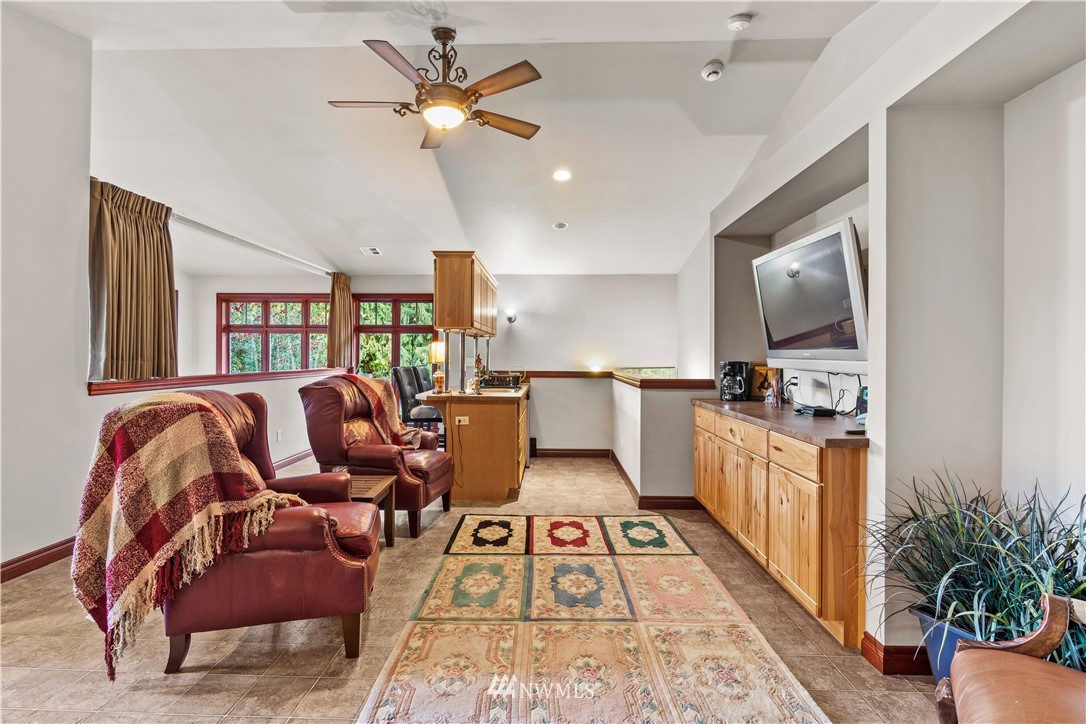 18100 Southeast 132nd Street Renton, WA 98059 - Photo 23 of 33 a living room with furniture and a flat screen tv