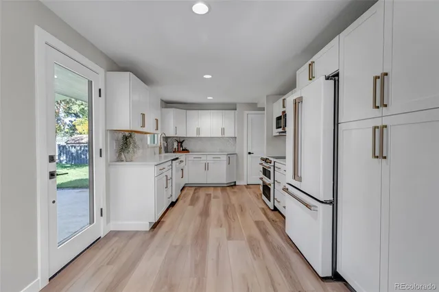 a kitchen with stainless steel appliances a refrigerator and a stove top oven