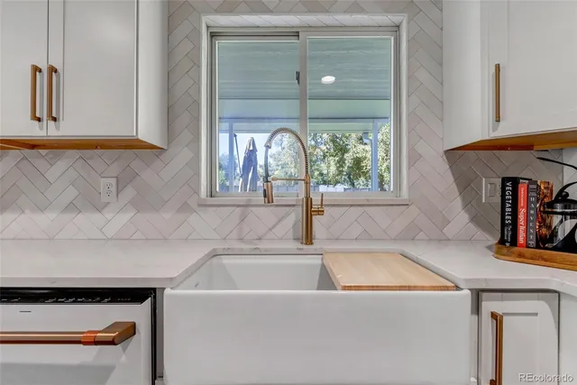 a view of a sink and dishwasher with wooden floor