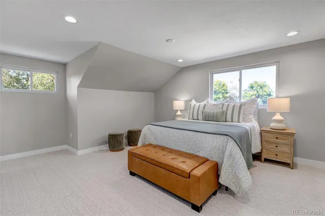 a bedroom with a bed and a night stand