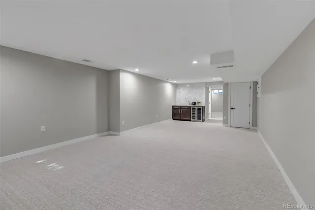 a view of empty room with a sink and a cabinet