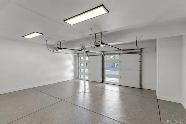 a view of a room with wooden floor a ceiling fan and windows