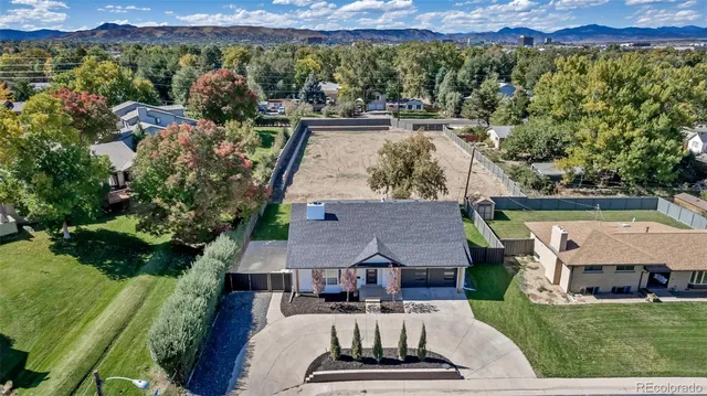 an aerial view of a house with a yard basket ball court and outdoor seating