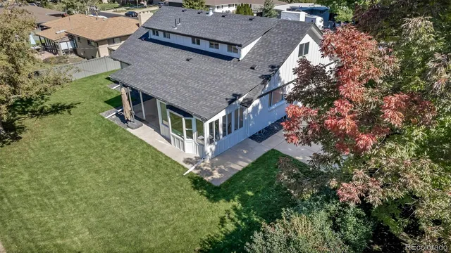 an aerial view of a house with a yard balcony