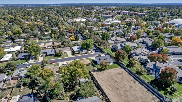 an aerial view of a house with a yard and lake view in back